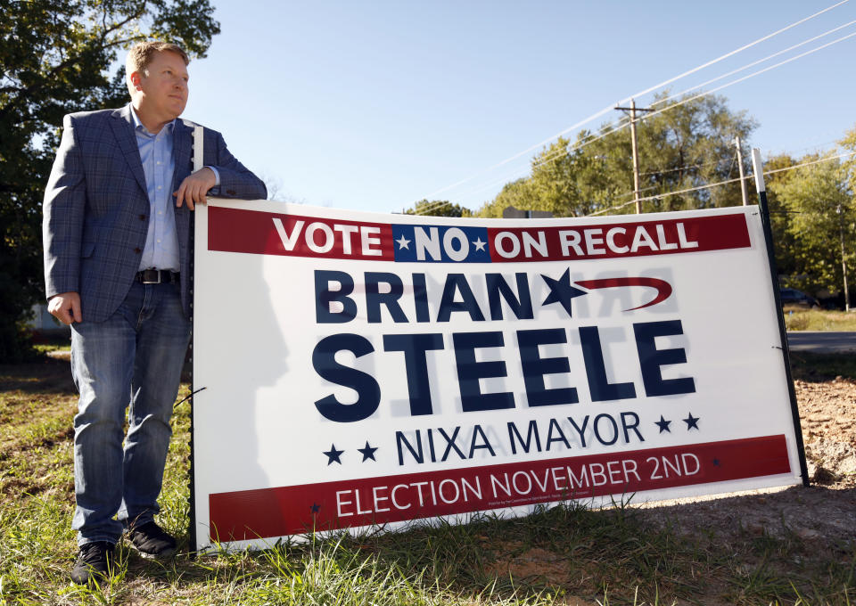 Brian Steele, Mayor of Nixa, is seen next to one of his campaign signs in Nixa, Missouri on Oct. 21,2021. Steele is facing a recall election on November 2 as a local conservative group has taken issue with some of the cities COVID-19 measures taken in the past year. (AP Photo/Bruce E. Stidham)