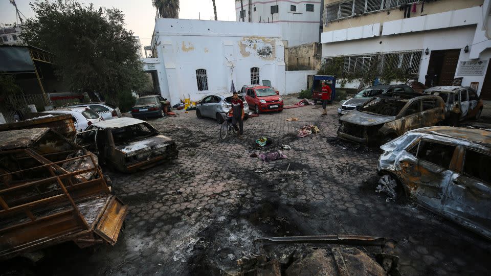 Palestinians assess the aftermath of the explosion at Al-Ahli Hospital on Wednesday, October 18. - Abed Khaled/AP