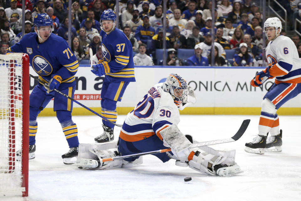 New York Islanders goaltender Ilya Sorokin (30) blocks a shot by Buffalo Sabres center Casey Mittelstadt (37) as left wing Victor Olofsson (71) watches during the first period of an NHL hockey game Thursday, Jan. 19, 2023, in Buffalo, N.Y. (AP Photo/Joshua Bessex)