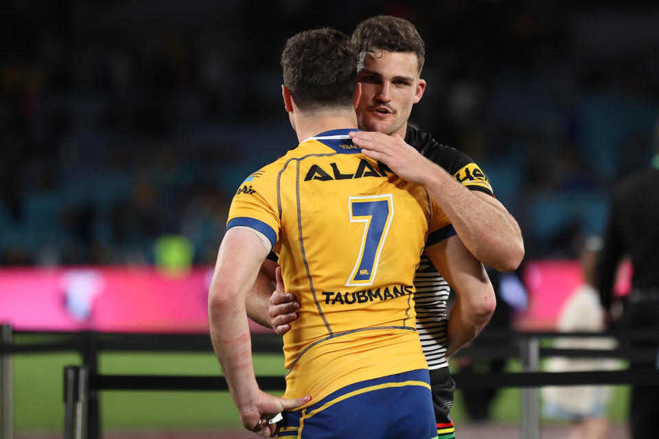 Nathan Cleary and Mitchell Moses embrace.