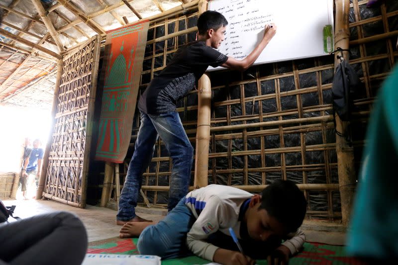 FILE PHOTO: Mohammed Tuahayran teaches English in a makeshift school at Kutupalong refugee camp in Cox’s Bazar