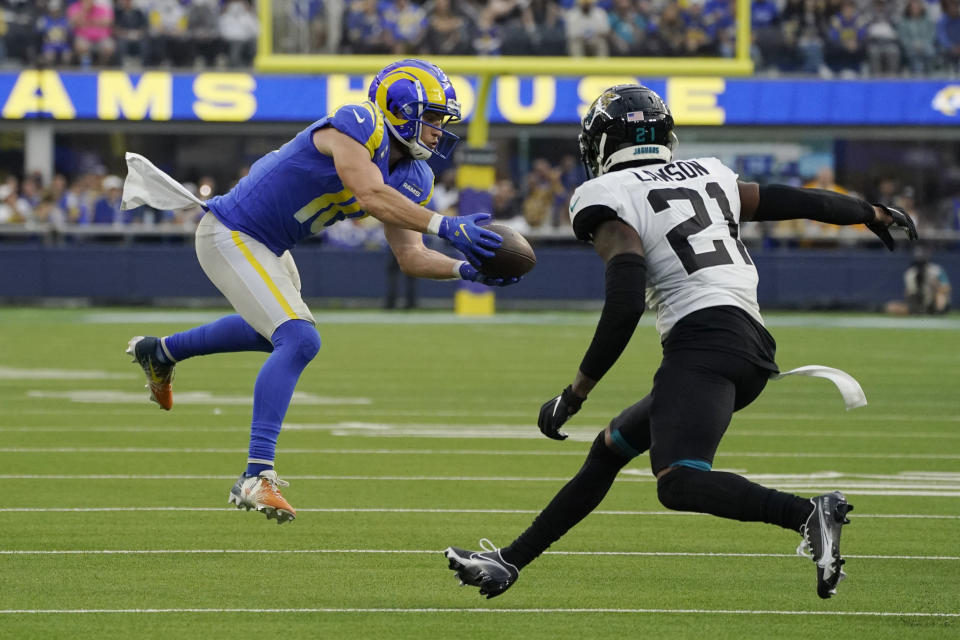 Los Angeles Rams wide receiver Cooper Kupp makes a catch next to Jacksonville Jaguars cornerback Nevin Lawson (21) during the first half of an NFL football game Sunday, Dec. 5, 2021, in Inglewood, Calif. (AP Photo/Mark J. Terrill)