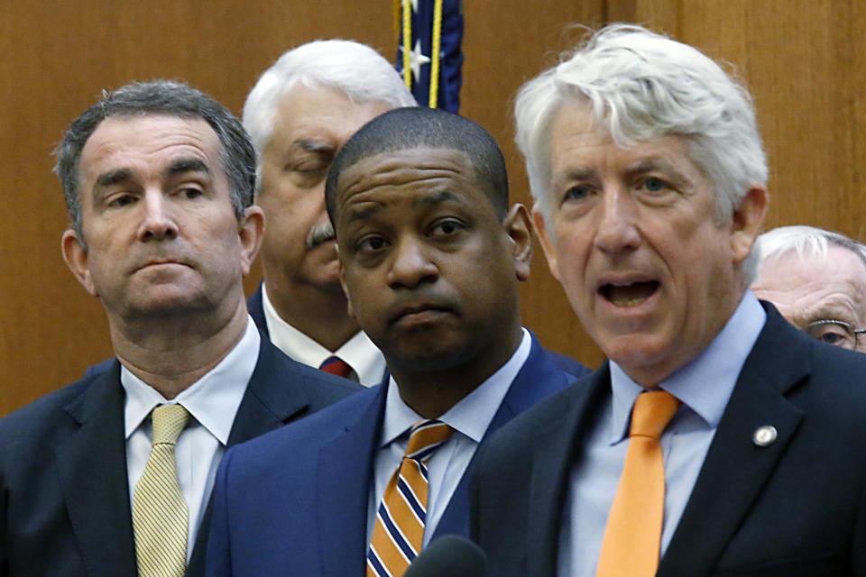 Virginia Governor Ralph Northam, left, and Lt. Gov. Justin Fairfax, center, listen to Attorney General Mark Herring, right, during a news conference inside the Patrick Henry Building in Richmond, Va. Tuesday, June 4, 2019. Northam is summoning lawmakers back to the state Capitol to consider a package of gun-control legislation after Friday's mass shooting in Virginia Beach. (Bob Brown/Richmond Times-Dispatch via AP)