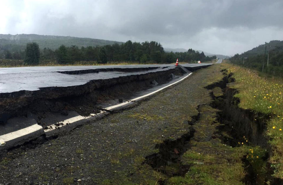 Cracks appear in and along a road near Quellon, Chile, Sunday, Dec. 25, 2016, after an earthquake. (Edinson Capdevilla/Aton via AP)