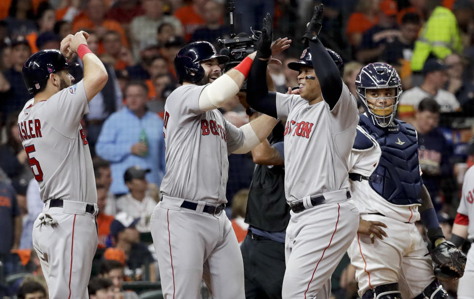 Boston Red Sox's Rafael Devers, right, celebrates his three-run home run against the Houston Astros during the sixth inning in Game 5 of a baseball American League Championship Series on Thursday, Oct. 18, 2018, in Houston.(AP Photo/David J. Phillip)