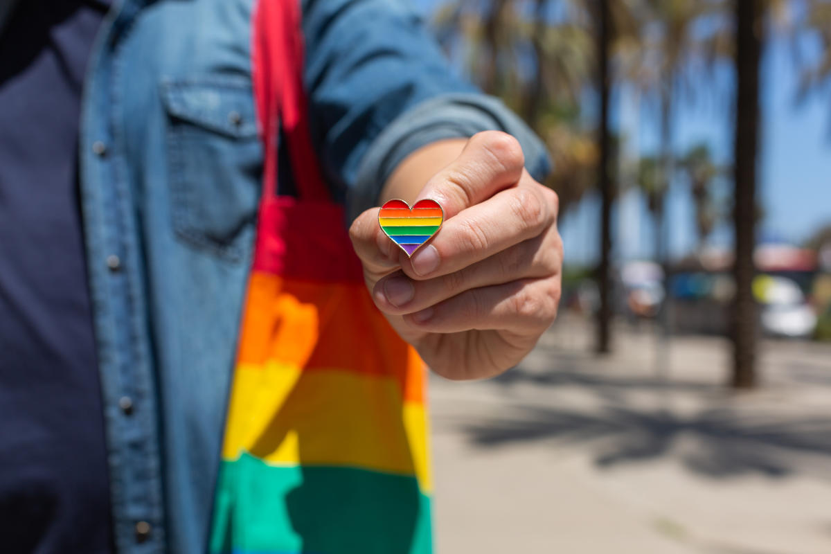 Asian lady wearing blue jean jacket or denim shirt and holding rainbow  color flag, symbol of LGBT pride month celebrate annual in June social of  gay, lesbian, bisexual, transgender, human rights. 3707220