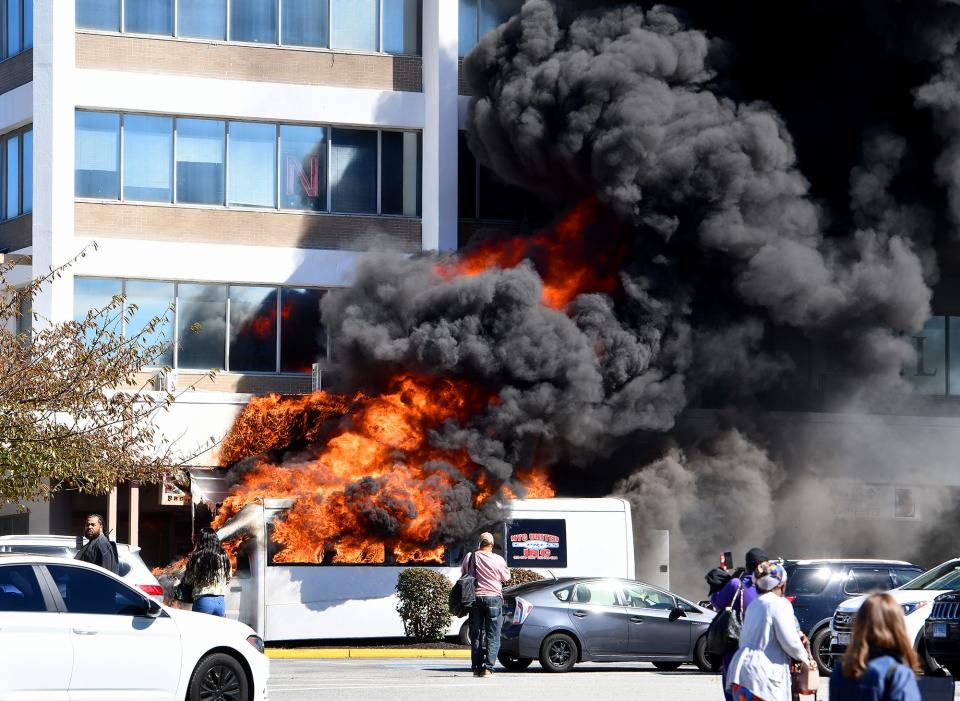 A NYC United Express passenger vehicle explodes into flames and thick, black smoke before the arrival firefighters at Madison Place shopping center.