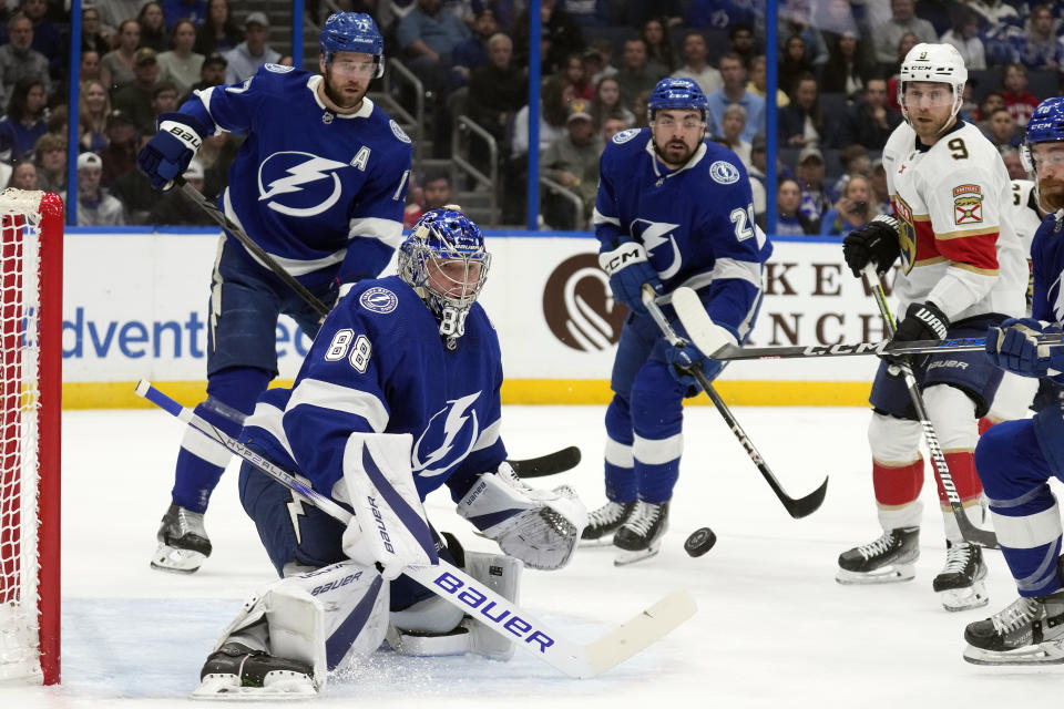 Tampa Bay Lightning goaltender Andrei Vasilevskiy (88) makes a save on a shot by Florida Panthers center Sam Bennett (9) during the first period of an NHL hockey game Wednesday, Dec. 27, 2023, in Tampa, Fla. (AP Photo/Chris O'Meara)