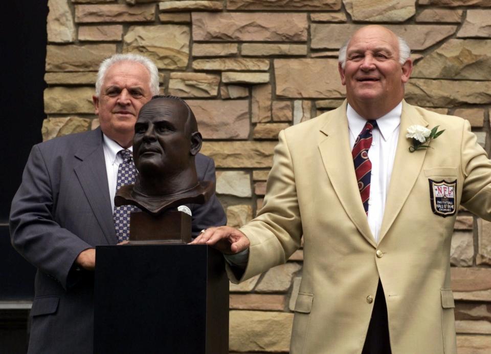 Former Buffalo Bills great Billy Shaw, right, poses with his bust and presenter Eddie Abramoski on Aug. 7, 1999, after enshrinement in the Pro Football Hall of Fame in Canton, Ohio.