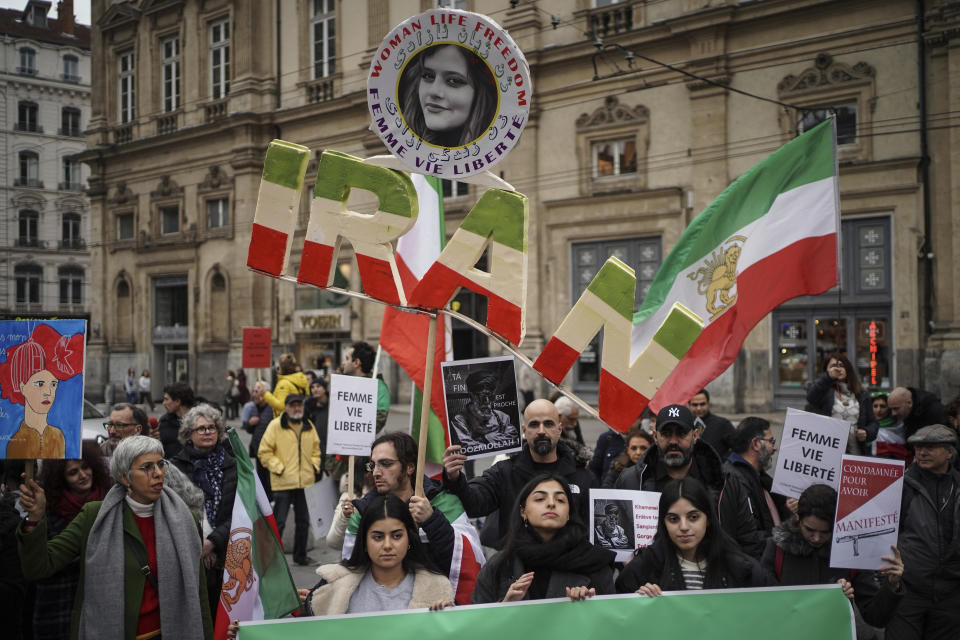 People demonstrate in Lyon, central France, Sunday, Jan. 8, 2023. Hundreds of people marched Sunday in France to honor an Iranian Kurdish man who took his own life in a desperate act of anguish over the nationwide protests in Iran. Police estimated the size of the crowd that gathered for Mohammad Moradi at about 1,000 people. They marched in the city of Lyon, where the 38-year-old Moradi took his own life in December, drowning in the Rhone river. (AP Photo/Laurent Cipriani)