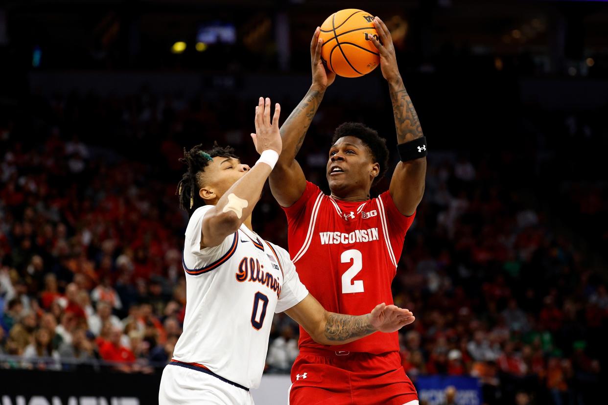 AJ Storr of the Wisconsin Badgers shoots the ball against Terrence Shannon Jr. of Illinois in the first half at Target Center in the Big Ten Tournament.