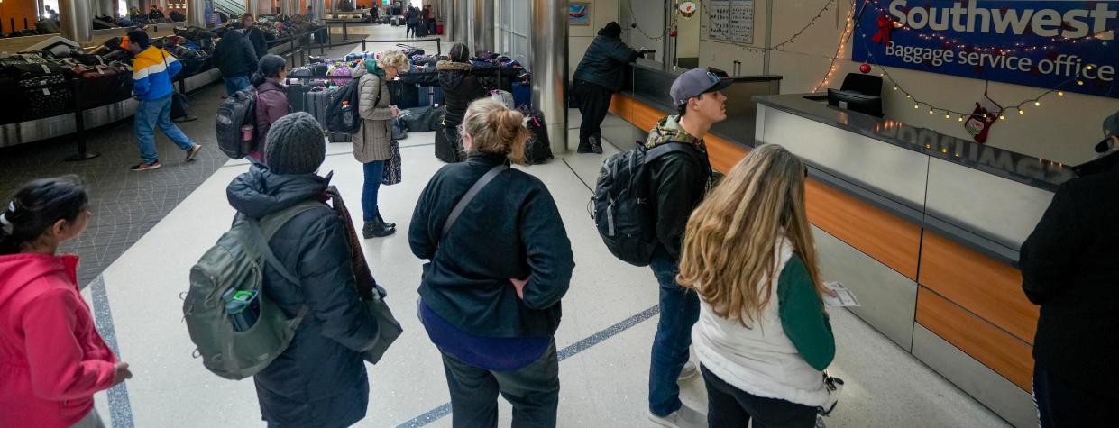 Southwest travelers wait in line at the baggage service office to retrieve their baggage following delays and cancellations that disrupted air travel over the Christmas holiday Tuesday, Dec. 27, 2022, at Milwaukee Mitchell International Airport.