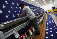 <p>A worker inspects a sheet of stars after embroidery at the FlagSource facility in Batavia, Illinois, U.S., on Tuesday, June 27, 2017. (Photo: Jim Young/Bloomberg via Getty Images) </p>