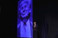 Former President Donald Trump applauds supporters as he arrives to speak at a Turning Point Action gathering, Saturday, July 24, 2021, in Phoenix. (AP Photo/Ross D. Franklin)