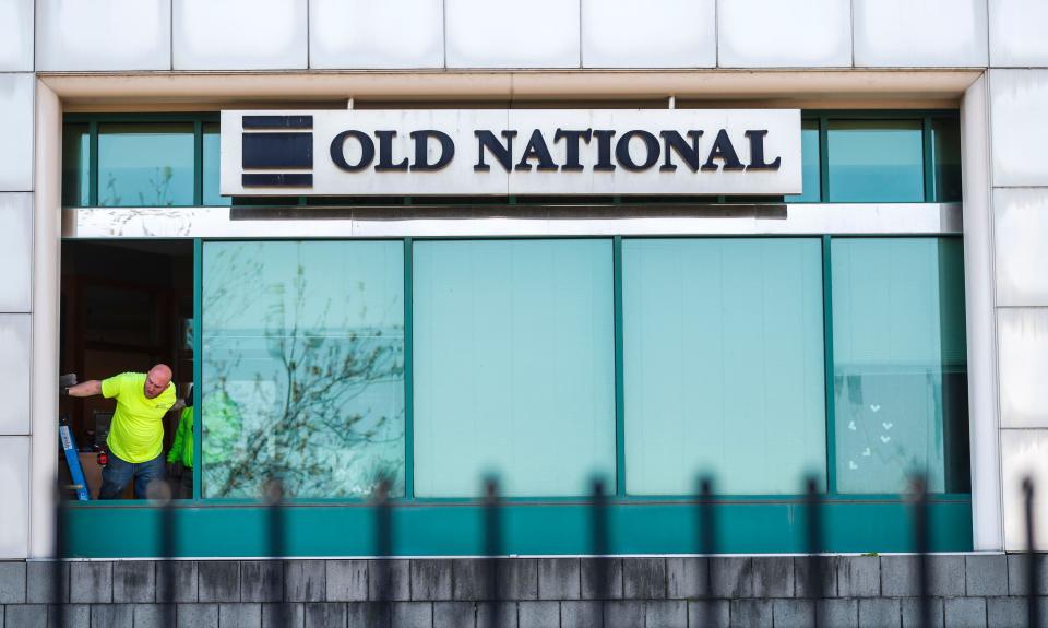 Workers replace glass on Tuesday, April 11, 2023, damaged by Monday's mass shooting, which killed five people and injured nine, including two Louisville Metro Police officers in downtown Louisville, Ky.