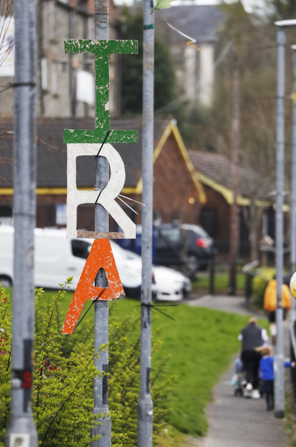 An Irish Republican Army sign hangs from a lamppost in Londonderry, Northern Ireland, Monday, April 3, 2023. It has been 25 years since the Good Friday Agreement largely ended a conflict in Northern Ireland that left 3,600 people dead. (AP Photo/Peter Morrison)
