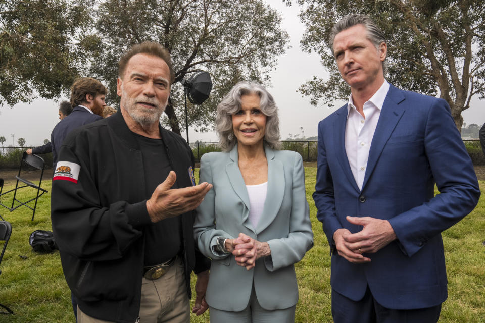 Jane Fonda, actor and climate activist, middle, poses with former California Governor Arnold Schwarzenegger, left, and Governor Gavin Newsom, as they join members of the Campaign for a Safe and Healthy California campaigning for Keep The Law (SB 1137) in Ladera Hills area of Inglewood, Calif., on Friday, March. 22, 2024. The law if upheld would require all oil or gas production facilities or wells within a health protection zone to comply with new regulations. (AP Photo/Damian Dovarganes)