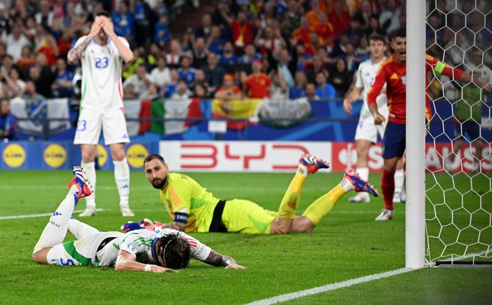 June 20: Italy players react after an own goal in the loss to Spain.