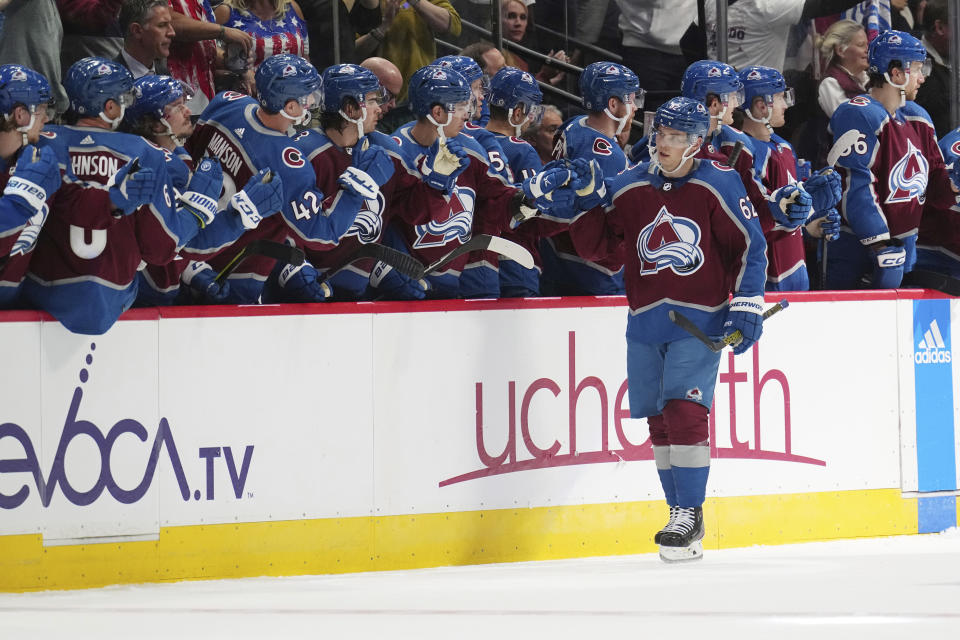 Colorado Avalanche left wing Artturi Lehkonen (62) is congratulated for his goal against the Chicago Blackhawks during the second period of an NHL hockey game Wednesday, Oct. 12, 2022, in Denver. (AP Photo/Jack Dempsey)