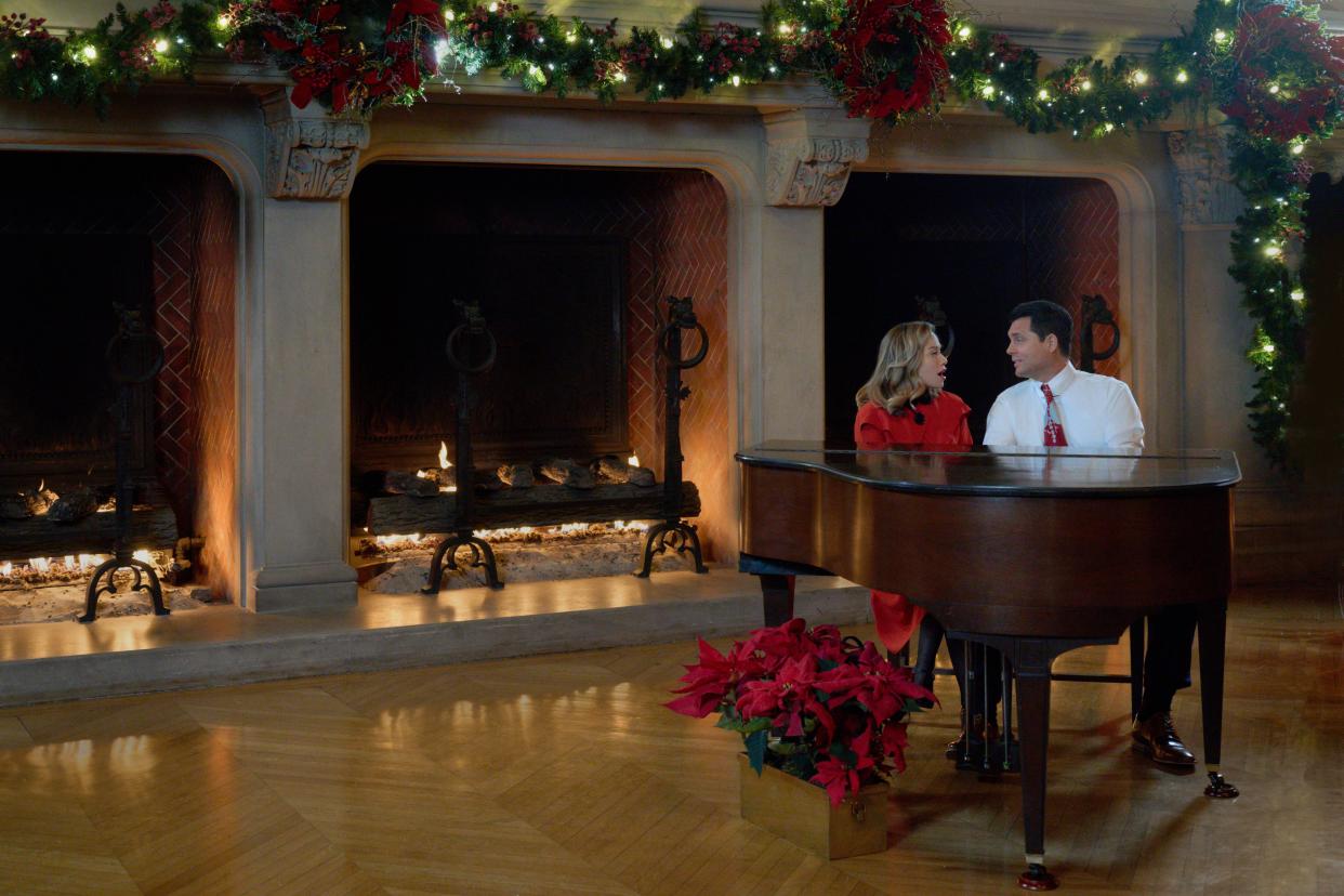 "A Biltmore Christmas" actors Bethany Joy Lenz and Kristoffer Polaha play the piano in the Biltmore House in Asheville. The holiday film will premiere on Nov. 26 on Hallmark Channel.