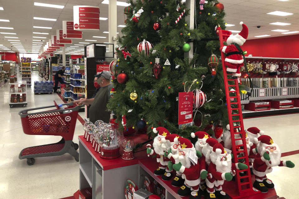 Shoppers walk past a display of Christmas decorations at a Target store, Sunday, Nov. 8, 2020, in Marlborough, Mass. (AP Photo/Bill Sikes)