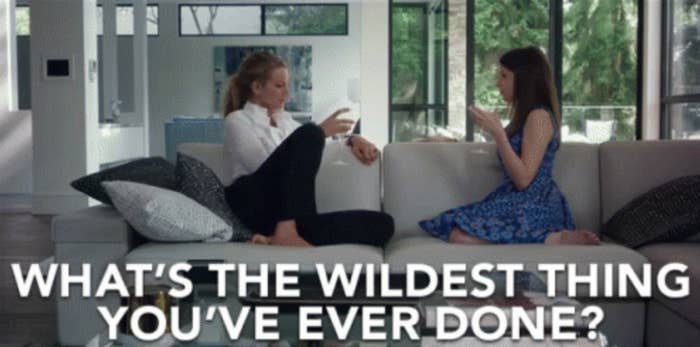 two women sitting on the couch asking, what's the wildest thing you've ever done
