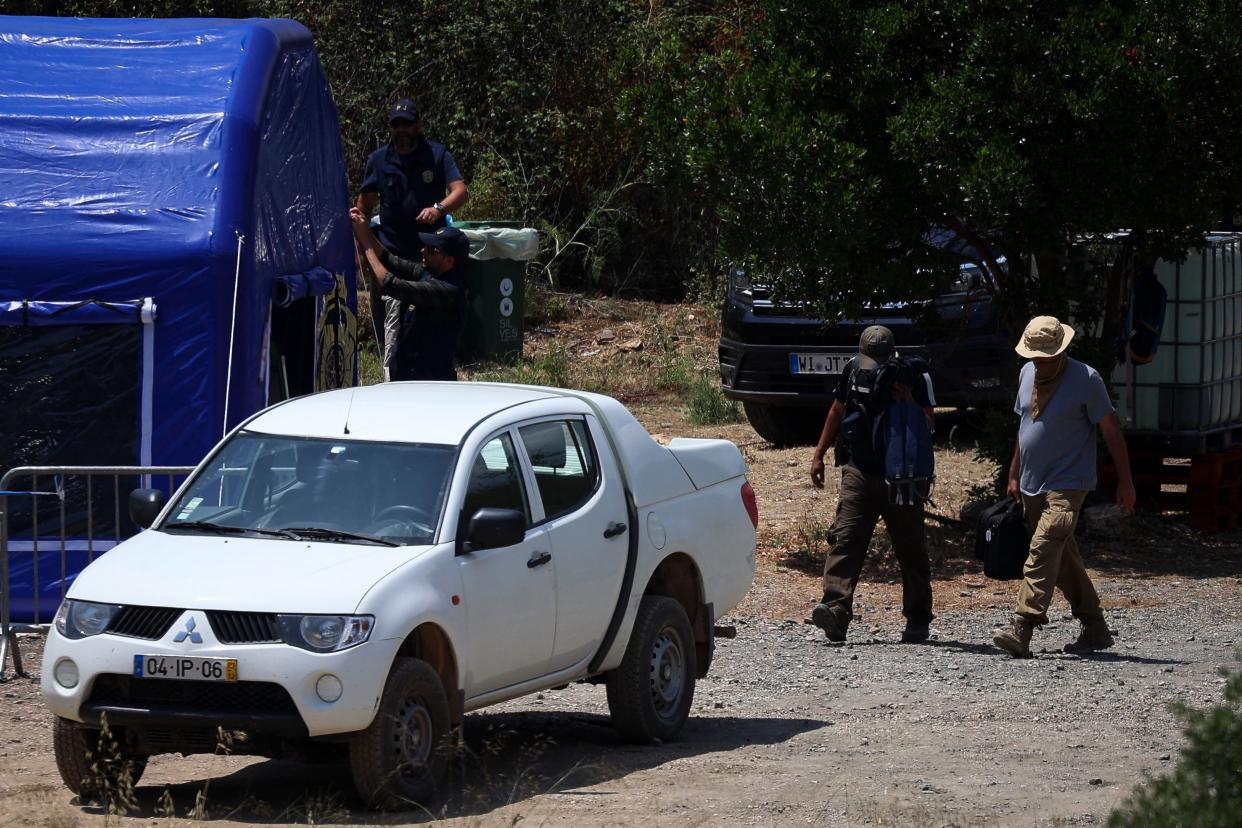 Portuguese Judicial Police (PJ) criminal investigation unit members leave the base camp set near the Arade dam in Silves on May 25 (AFP via Getty Images)