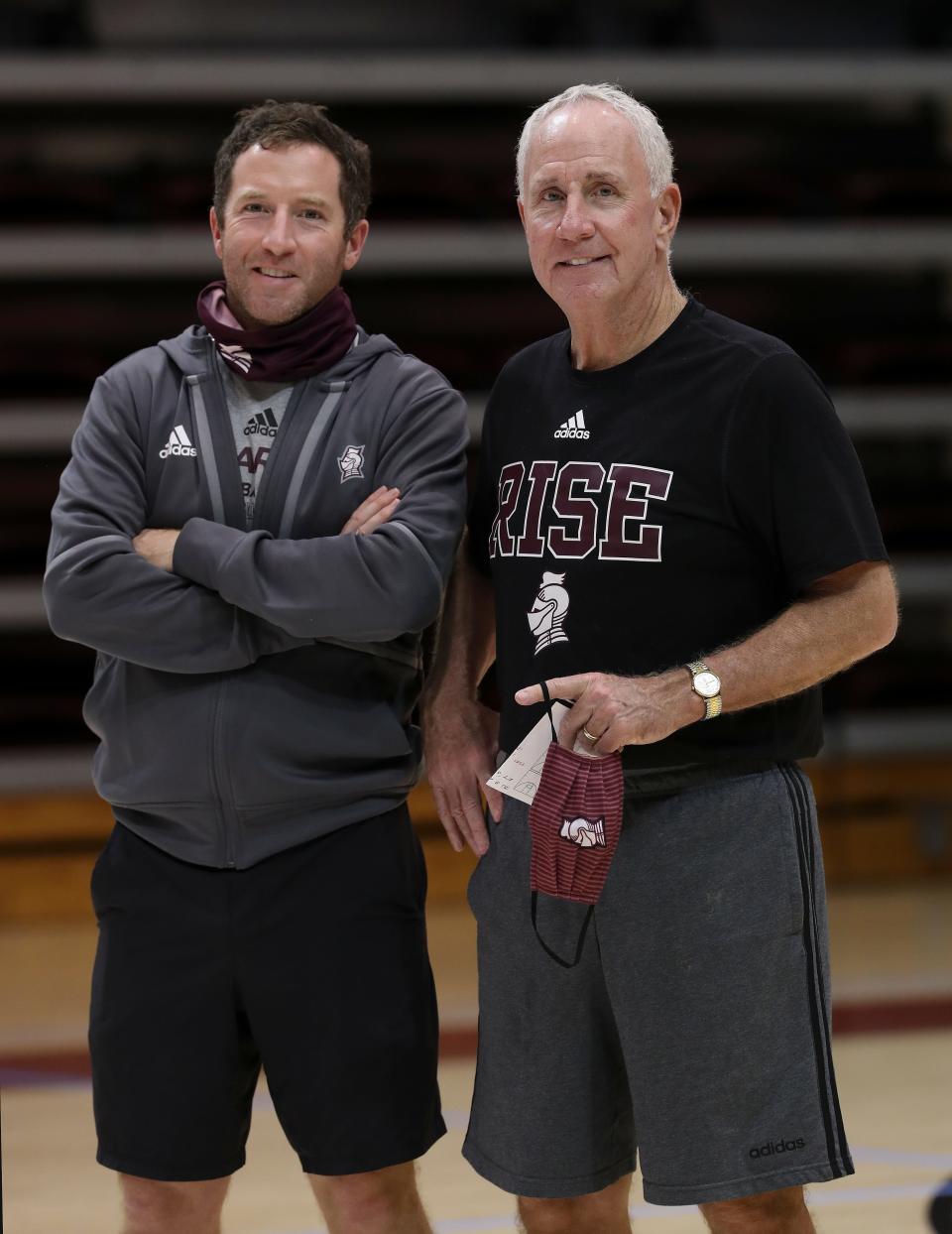 Bellarmine head basketball coach Scott Davenport, right, and his son assistant coach Doug Davenport during practice at Knights Hall in Louisville, Ky. on Dec. 28, 2020.  