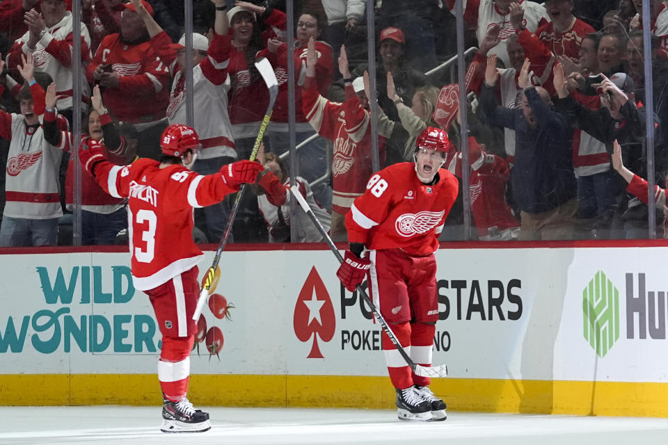 Detroit Red Wings right wing Patrick Kane (88) celebrates his goal with Alex DeBrincat (93) in the second period of an NHL hockey game against the Buffalo Sabres, Saturday, March 16, 2024, in Detroit. (AP Photo/Paul Sancya)
