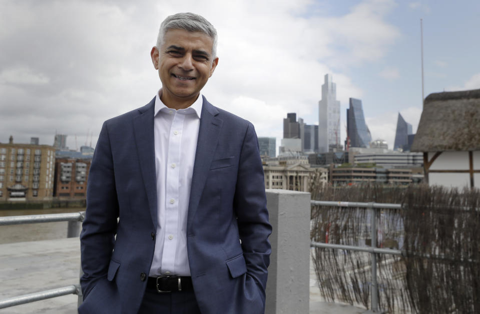 FILE - In this file photo dated Monday, May 10, 2021, Sadiq Khan the Mayor of London poses for a photograph outside Shakespeare's Globe Theatre in London. Khan on Thursday July 22, 2021, sent a message of support to Hong Kong people fleeing China’s crackdown on democracy to seek a new life in the U.K., saying his office will spend 900,000 pounds (dollars 1.2 million US) to help new arrivals with housing, education and finding jobs. (AP Photo/Kirsty Wigglesworth, FILE)