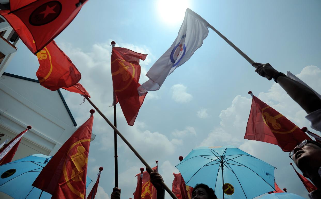 Supporters of various political parties display party flags on Nomination Day on September 1, 2015. (Photo: MOHD FYROL/AFP via Getty Images)