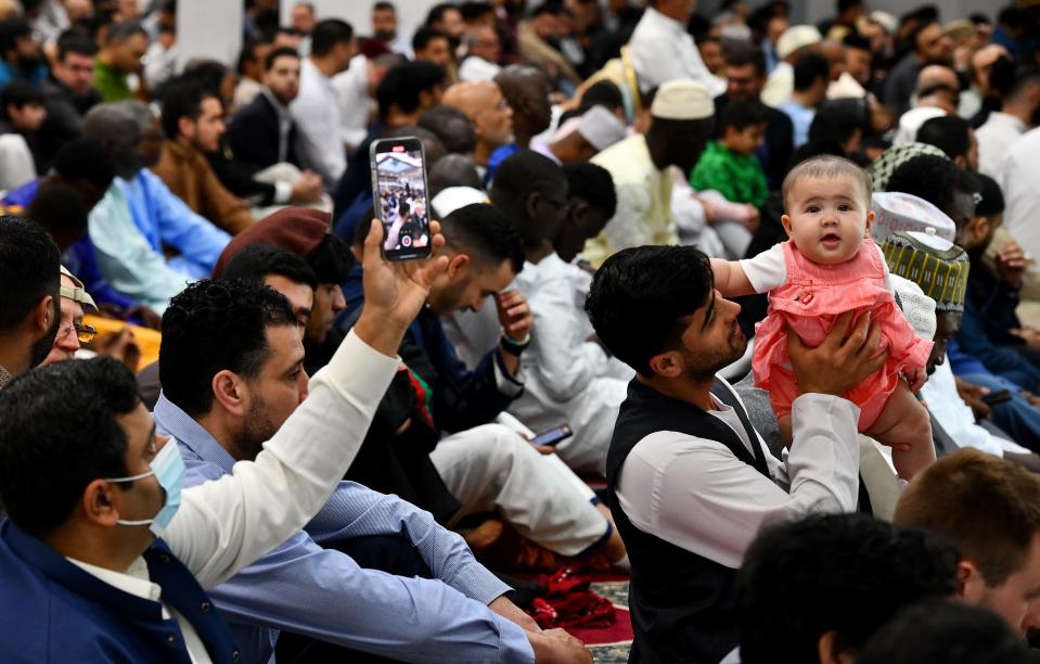 Hosha Sadat of Worcester holds up his 6-month-old daughter, Shakrullah, during a special prayer to start the Eid al-Fitr celebration at the Worcester Islamic Center on Friday.