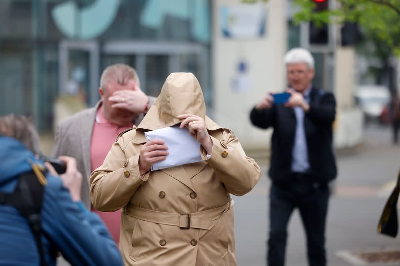 Ann and Bernard McDonagh covering their faces outside the court