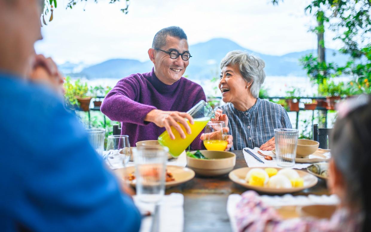 Cheerful senior man and woman at dining table