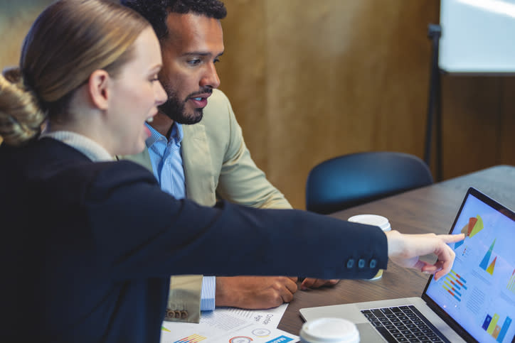 Two investors reviewing the performance of their portfolio.