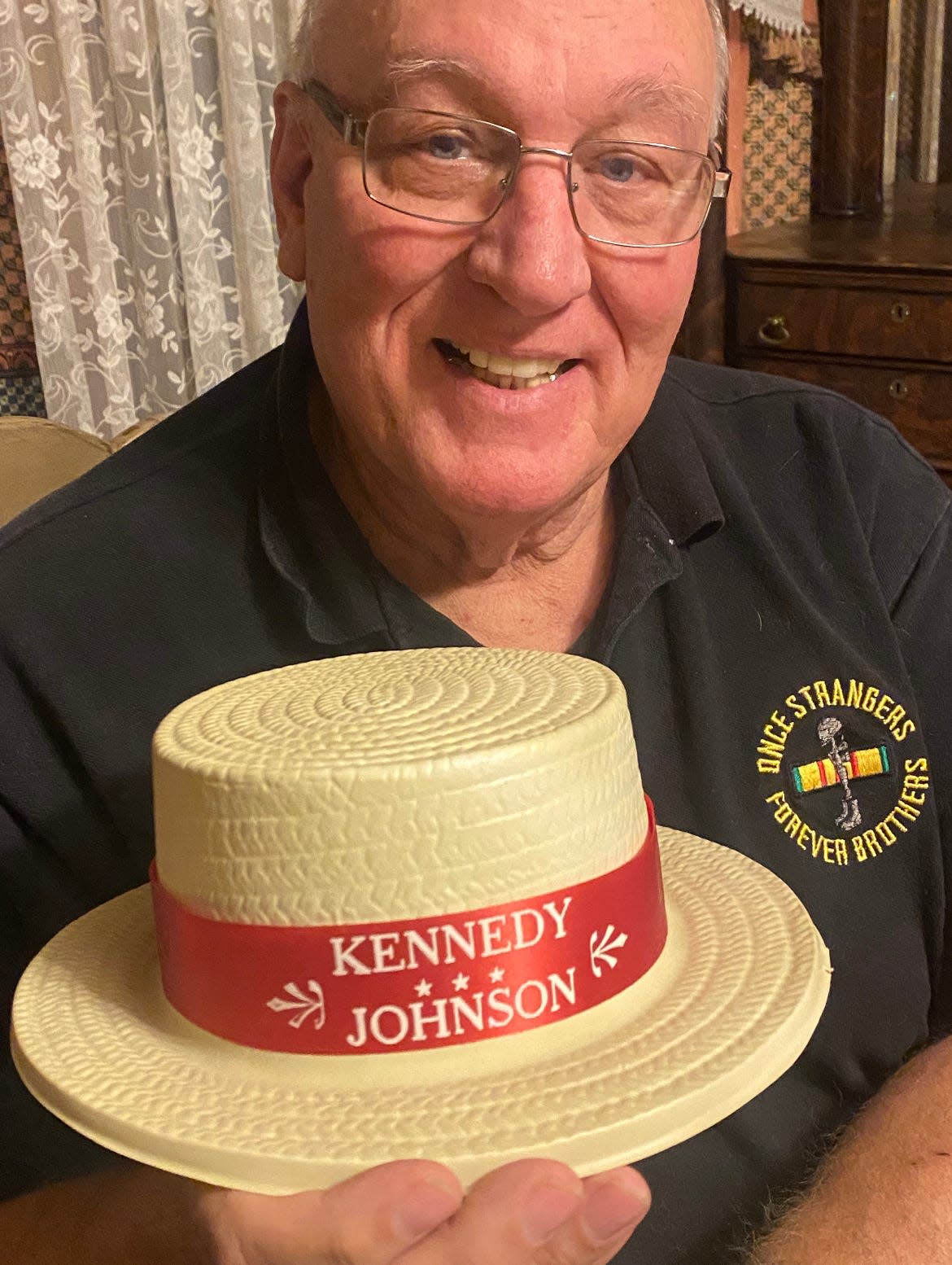 Listening to a speech by Democratic presidential candidate Sen. John F. Kennedy gave Randy Feemster of New Philadelphia a lifelong interest in collecting artifacts related to Kennedy. He holds a hat from the 1960 presidential campaign.