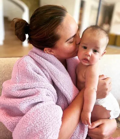 Chrissy Teigen Instagram Chrissy Teigen holds her daughter, Esti