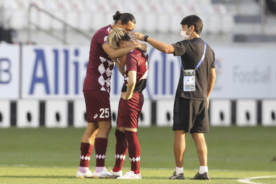 Vissel Kobe stand in dejection end of the Champions League semifinal soccer match between Vissel Kobe and Ulsan Hyundai FC at Jassim Bin Hamad Stadium in Doha, Qatar, Sunday, Dec. 13, 2020. Vissel Kobe lost 1-2. (AP Photo/Hussein Sayed)