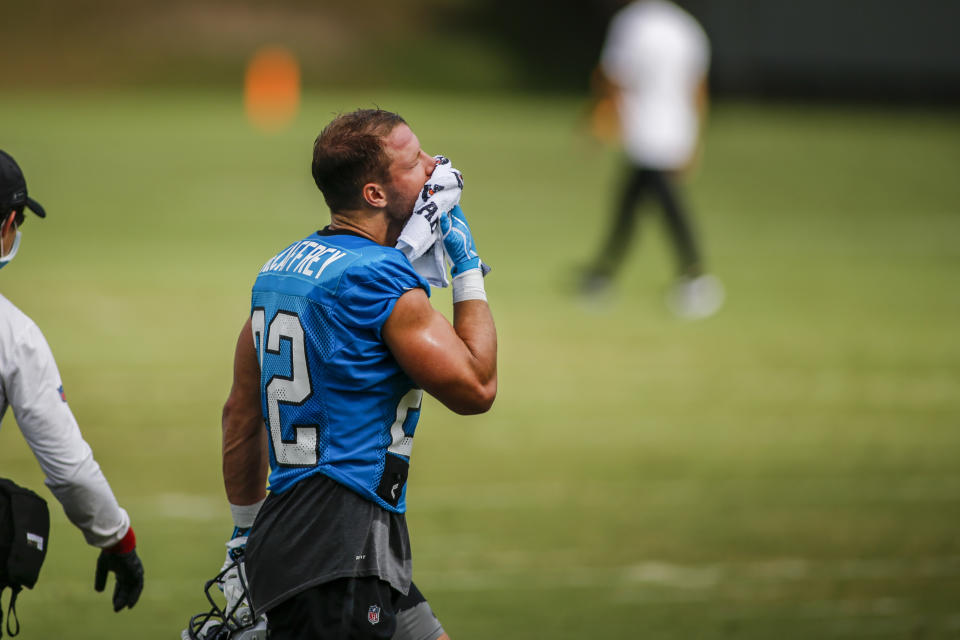 Carolina Panthers running back Christian McCaffrey wipes his face during a break in the action at the NFL football team's training camp practice Sunday, Aug. 16, 2020 in Charlotte, N.C. (AP Photo/Nell Redmond)