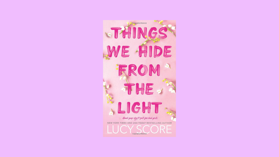 Curl up with Lucy Score's newest book, "Things We Hide from the Light."