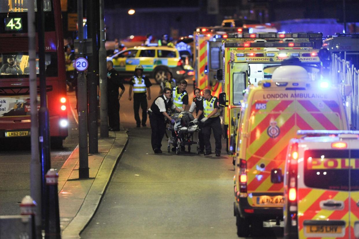 Police officers and paramedics attend to a person injured in a terror attack on London Bridge on June 3: AFP/Getty Images