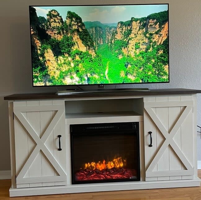 Reviewer's photo of the fireplace TV stand.