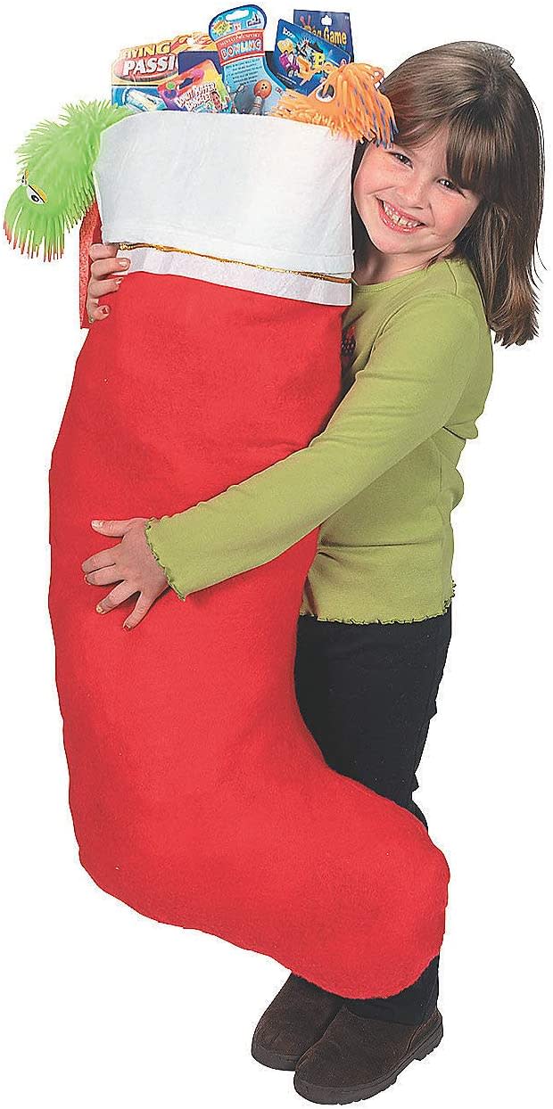 little girl holding a Fun Express Giant X-Large Christmas Stocking