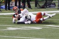 Cincinnati Bengals quarterback Joe Burrow, left, is sacked by Cleveland Browns' Myles Garrett (95) during the first half of an NFL football game, Sunday, Oct. 25, 2020, in Cincinnati. (AP Photo/Bryan Woolston)