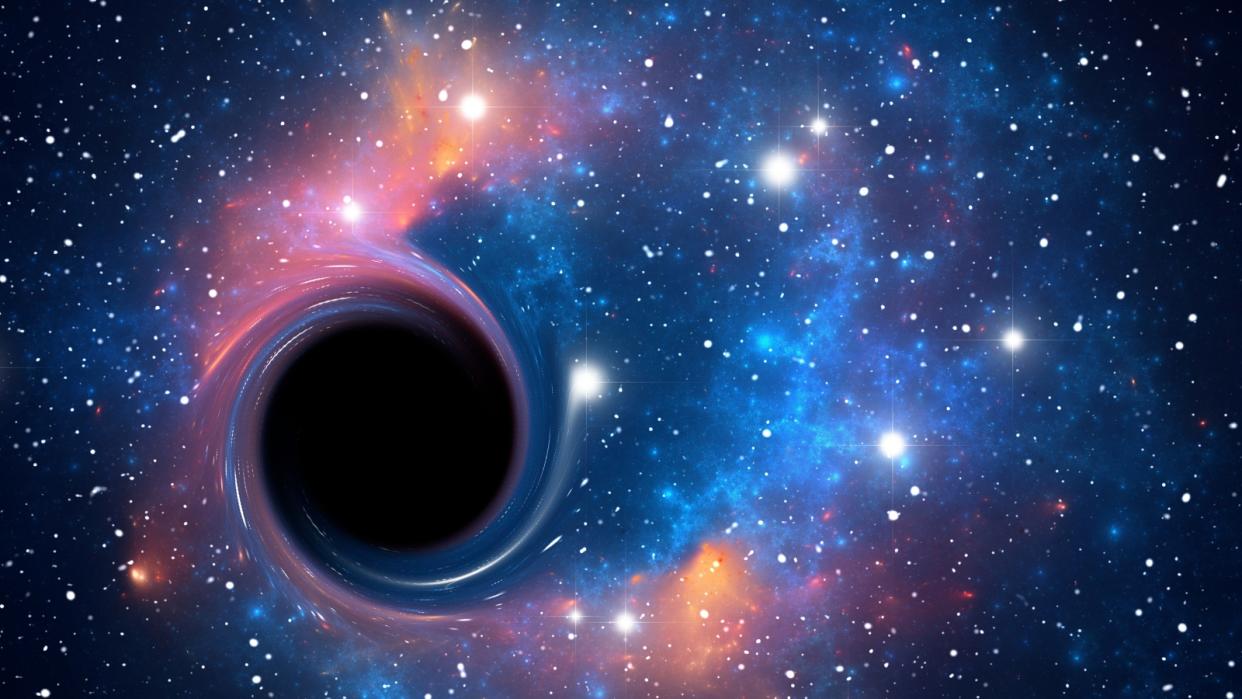  An artist's interpretation of a black hole surrounded by stars. 