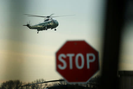 U.S. President Donald Trump arrives aboard the Marine One to greet the remains of a U.S. military commando killed during a raid on the al Qaeda militant group in southern Yemen on Sunday, at Dover Air Force Base, Dover, Delaware, U.S. February 1, 2017. (Note: photograph was made from the interior of a media vehicle.) REUTERS/Jonathan Ernst
