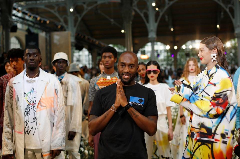 Designer Virgil Abloh, centre, accepts applause as he poses with other models including Gigi Hadid, right, at the conclusion of the Off White mens Spring-Summer 2020 fashion collection presented in Paris, Wednesday, June 19.