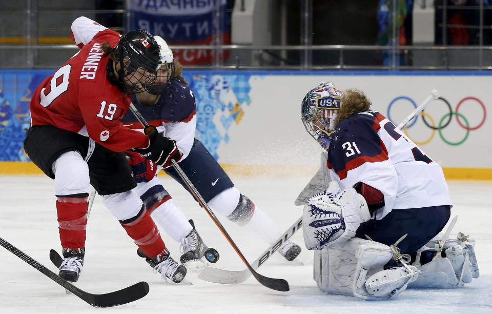 Team USA's goalie Vetter makes a save on Canada's Jenner during the first period of their women's ice hockey game at the Sochi 2014 Sochi Winter Olympics