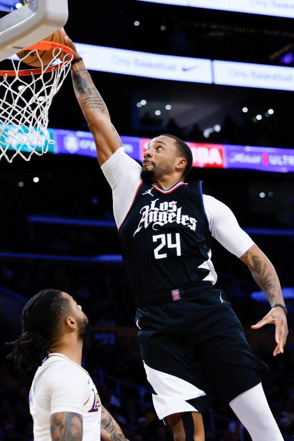 Clippers guard Norman Powell dunks over Lakers guard D'Angelo Russell during a game in January.