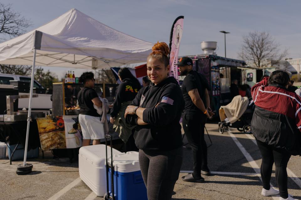 Cynthia Soto, owner of Empanada Lady, center, stands for a portrait outside her food stand.